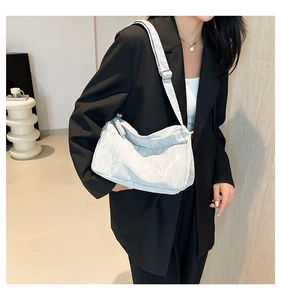 Chic wrinkled texture white tote bag shown on shoulder for a stylish commuter look