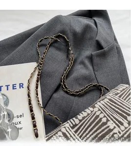 Detail of woven chain strap and textured fabric on the retro shoulder tote bag
