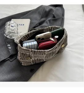 Top view of spacious woven tote interior showing phone, wallet and daily organizers