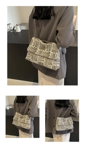 Detail of vintage geometric woven bag with textured tweed fabric and elegant chain strap