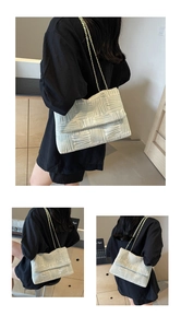 Detail of light green jacquard chain shoulder bag with geometric woven texture