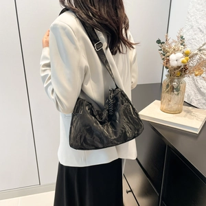 Minimalist black wrinkled leather tote bag with adjustable shoulder strap for women