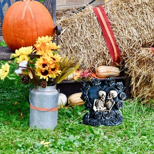 Skeleton couple on black rose heart base with Halloween pumpkins and autumn decor