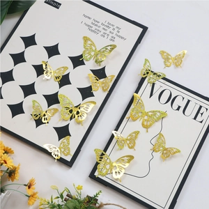 Macro shot of 3D gold glitter hollow butterfly wall stickers in various sizes with floral decor