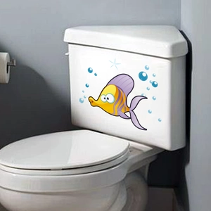 Green luminous tropical fish and bubble wall stickers on a white toilet tank