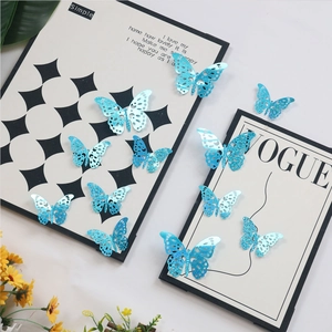 Detailed 3D hollow blue butterfly wall stickers with glitter on a white table set