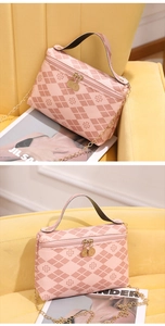 Detailed view of pink quilted handbag with clover print and gold chain strap