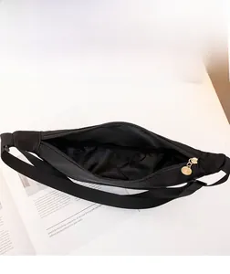 Detailed interior of black nylon crossbody bag with gold ring zipper and wide opening