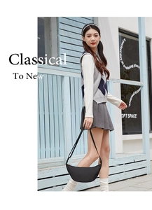 Outdoor shot of a black crescent moon shoulder bag worn with a stylish学院 outfit