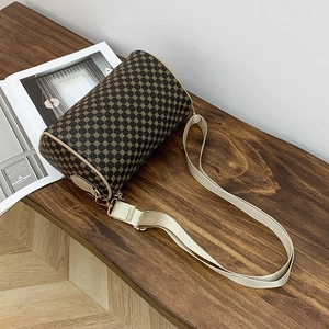 Floral cylinder crossbody bag with gold geometric print and wide adjustable shoulder strap