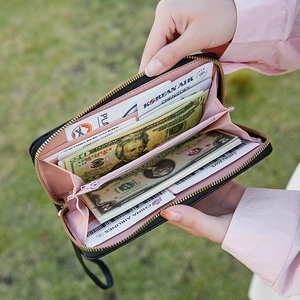 Women's black long zip wallet with pink interior lining and multi-card slots detail