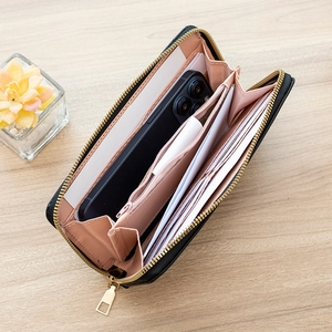 Black long zip-around wallet with embroidered texture and multiple card slots