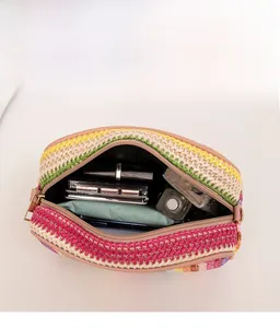 Macro view showing the spacious interior of striped woven bag with cosmetics and zipper