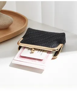 Detail of black woven texture coin purse with vintage gold metal frame and ball clasp