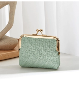 Detail of mint green woven shell coin purse with premium gold-tone metal clasp closure