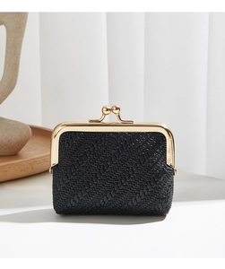 Detail view of black woven texture coin purse with elegant gold kiss-lock closure