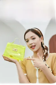 Detail of neon yellow jelly bag showing clear PVC texture and gold chain strap