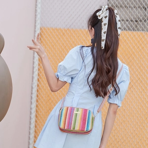Colorful striped woven crossbody straw bag with pink shoulder strap for summer style
