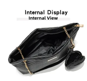 Internal display of black quilted tote bag with gold chain and mini pouch attachment