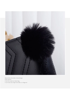 Detail showing the black leather wave embroidery and soft pompom charm on a woman long wallet