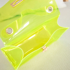 Neon green transparent jelly crossbody bag with gold chain strap and metal lock closure