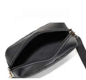 Internal display of black quilted camera bag showing spacious compartment and zipper