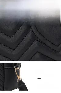Detail of waterproof quilted leather with wave stitching and gold hardware hooks