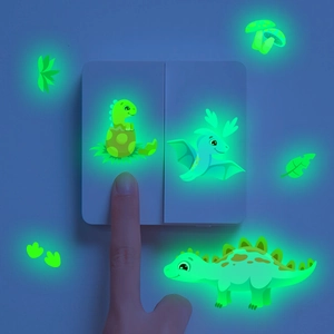 Luminous green dinosaur stickers glowing in the dark around a wall light switch