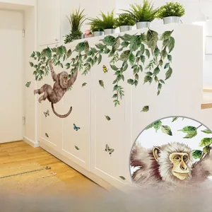 Detail of self-adhesive watercolor monkey and leaves wall decal with easy-to-remove backing