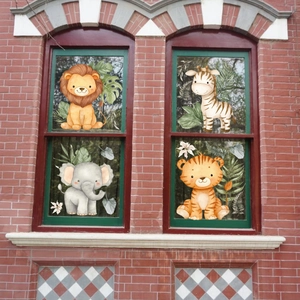 Cartoon lion zebra elephant tiger window stickers with tropical green leaves set