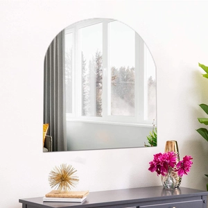 Modern frameless arched wall mirror shown in a bright interior living room setting