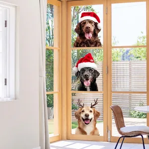 Christmas dog window stickers with Santa hats and reindeer antlers on sunny glass door