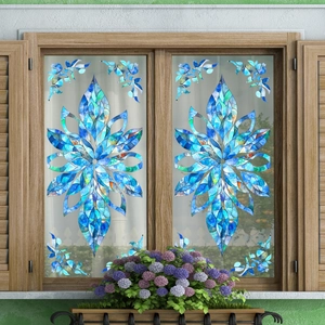 Artistic blue floral mosaic window sticker with a symmetrical flower pattern on a glass pane