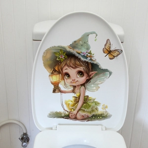 Détail d'un autocollant mural fée verte lumineuse sur le couvercle d'un abattant de WC