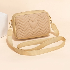 Minimalist light yellow crossbody camera bag with wave quilted heart pattern