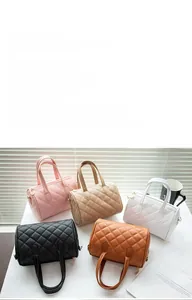Classic quilted Boston handbags in five colors displayed with stylish props and soft light