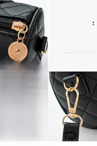 Detail view of black quilted leather with premium gold zipper and metal lobster clasp