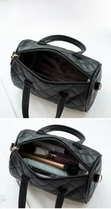 Interior view showing large capacity for daily items in black quilted Boston bag