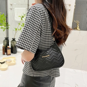 Chic black wave-quilted PU leather underarm bag with gold metal logo for women