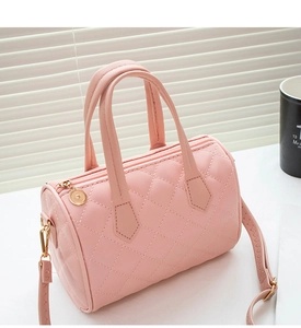 Close-up of pink quilted Boston bag showing detailed embroidery and gold zipper hardware