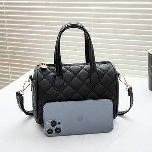 Classic black quilted Boston handbag in mini size with double handles and gold hardware