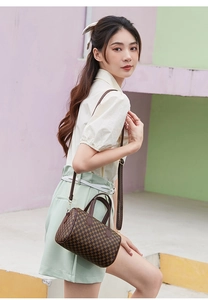 Detail of vintage brown monogram boston bag with leather handles and slim strap