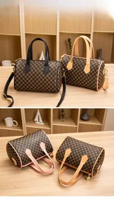 Close-up of printed Boston bags in black and pink with gold metal hardware details