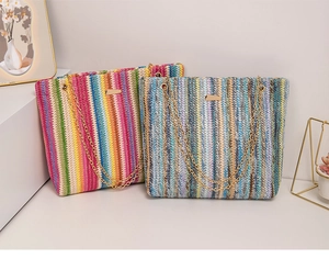 Detalle de bolsos tote tejidos de colores con correas de cadena dorada y detalles metálicos