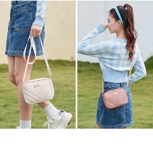 Detailed outdoor shot of beige and pink quilted camera bags for women with metal logo