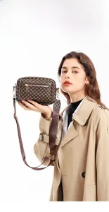 Detail of trendy crossbody camera bag with retro dot print and adjustable strap