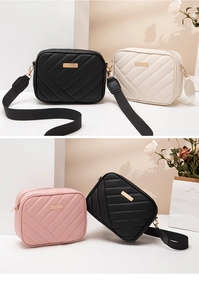 Detailed view of quilted camera bags in black, white, and pink with wide woven straps