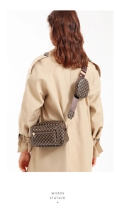Detail of crossbody camera bag with polka dot pattern and mini round coin purse attachment