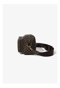 Close-up of geometric pattern crossbody camera bag with front pocket and gold D-ring hardware