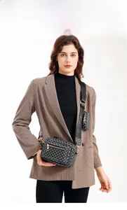 Detail of crossbody camera bag with geometric lattice pattern and mini coin purse